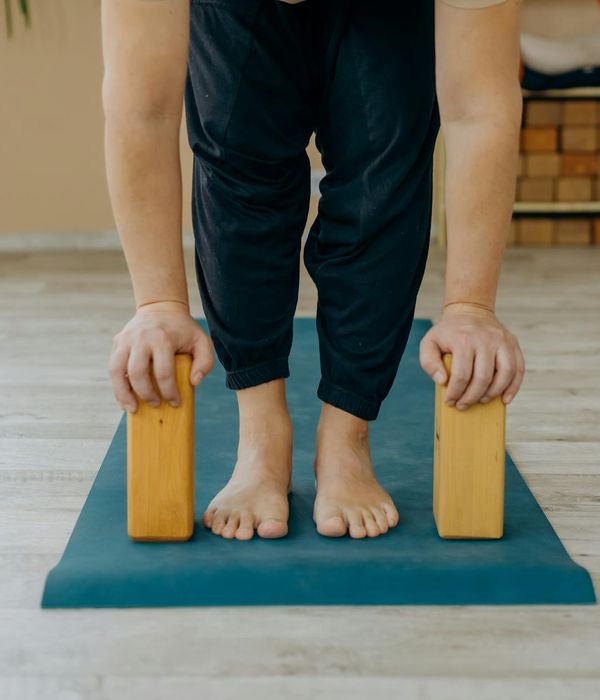 Person doing a gentle stretching exercise in a calm environment.